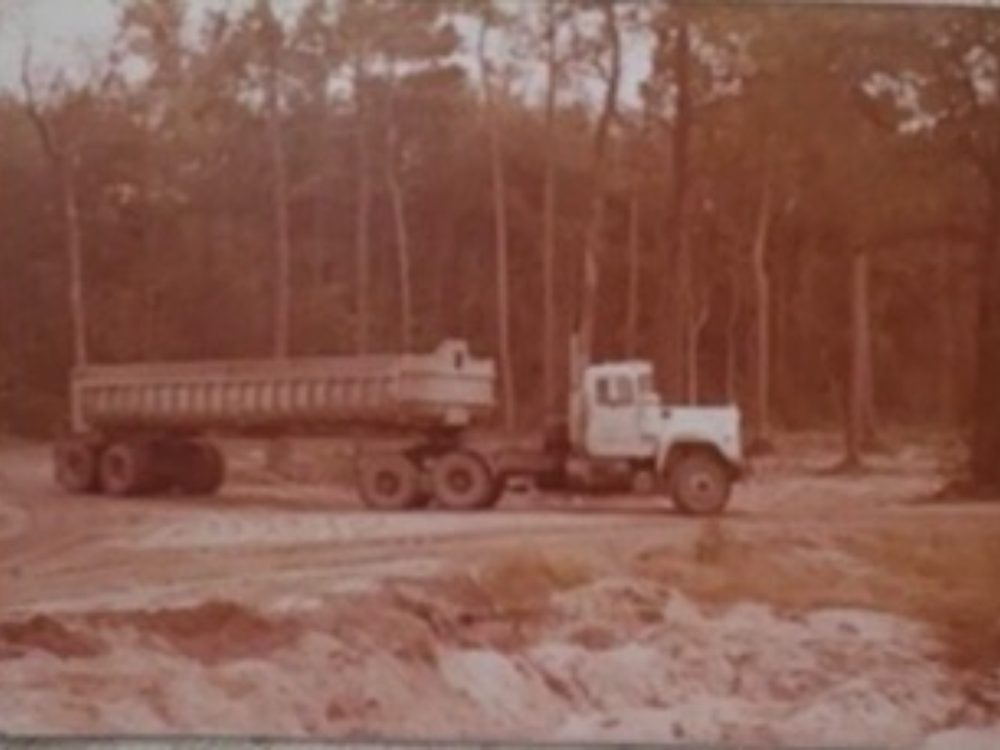 Edwards dump trailer hauling on a sand road through the pines, late 1970s