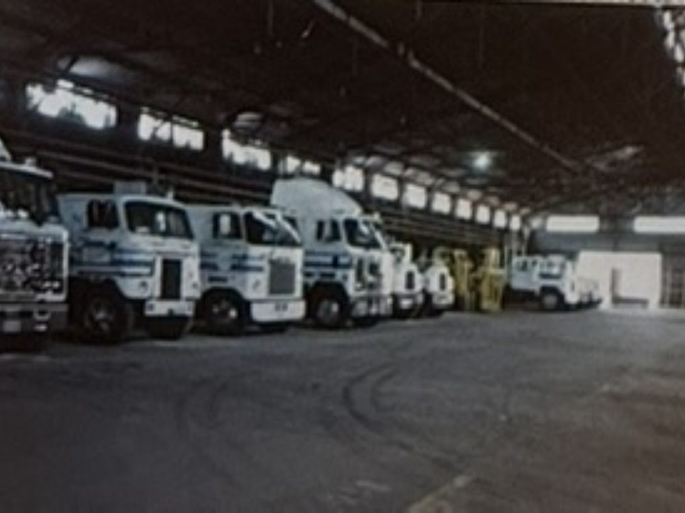 Edwards cabover tractor fleet lined up inside the Houston warehouse, 1980s