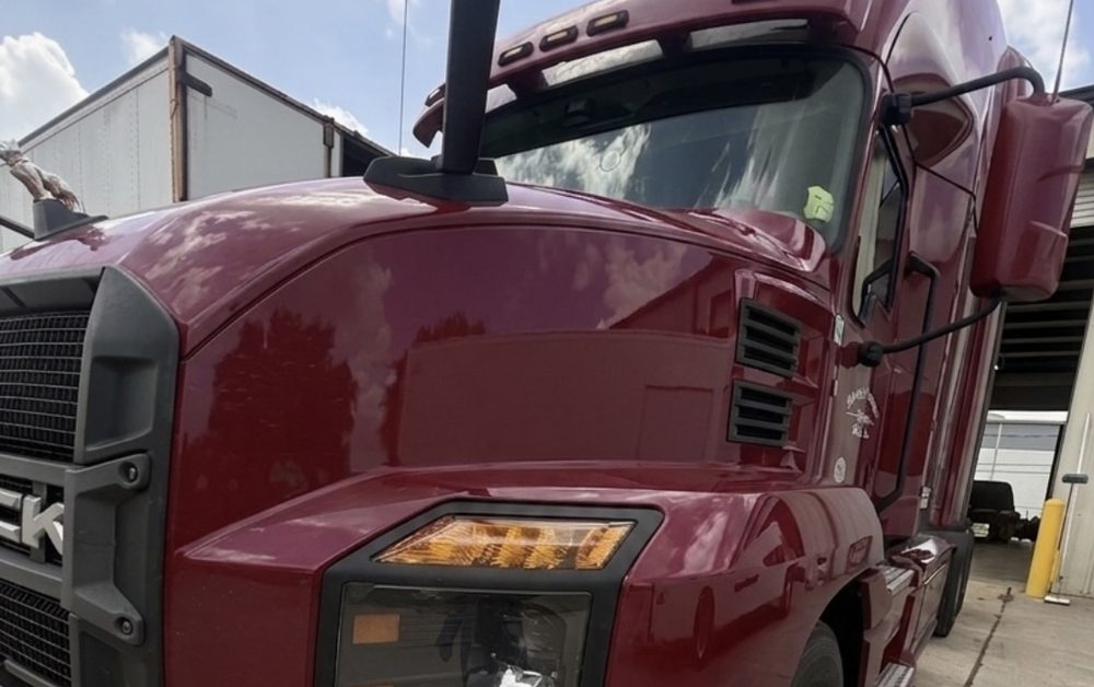 Late-model maroon Mack Anthem sleeper tractor in the Edwards Transport Services yard